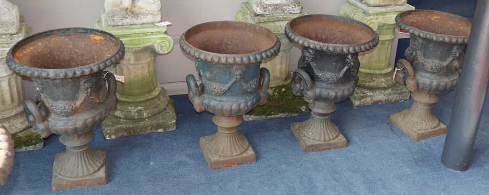 A set of four cast iron campana-shaped urns, H.59cm, W.43cm